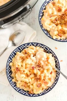 two bowls filled with macaroni and cheese on top of a table