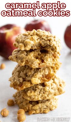 three oatmeal cookies stacked on top of each other with apples in the background