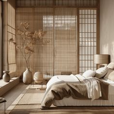 a bed sitting in a bedroom next to a window covered in bamboo blindes and pillows