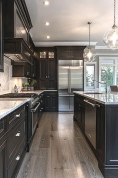 a large kitchen with dark wood cabinets and stainless steel appliances, along with marble counter tops