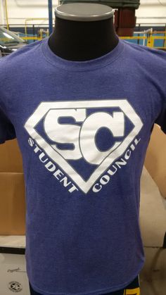 a t - shirt that says student council is on display in a room with other items