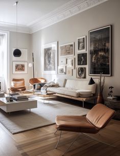 a living room filled with furniture and pictures on the wall