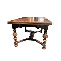 an old wooden table with two legs and a square top on it's base