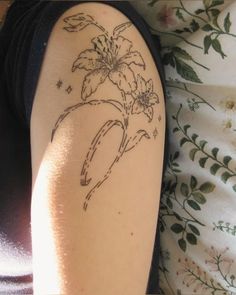 a woman's arm with a tattoo on it that has flowers in the center