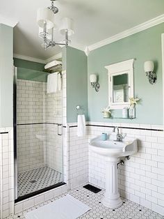 a bathroom with green walls and white tiles on the floor is pictured in this image