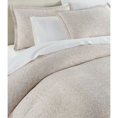 an image of a bed with white sheets and pillows