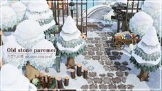 an old stone pavement is surrounded by trees and bushes in the snow, with a sign that says old stone pavement