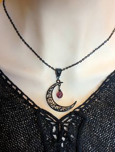 Unleash your inner Goddess... This crescent moon necklace is a magickal piece of celestial jewelry. It features an inky black filigree crescent moon with an amethyst purple faceted glass bead. Mysterious and witchy even! This darkly delightful noir necklace is sure to please! Size: The moon pendant measures 1 9/16" (40mm) long by 1 5/16" (32mm) wide. The black finished brass cable style chain is 1/8" wide (4mm) and comes in your choice of length (select from the drop-down menu). Lobster clasp cl Obsidian Necklace, Black Moon, Vintage Inspired Jewelry, Crescent Moon Necklace, Celestial Jewelry, Amethyst Purple, Moon Pendant, Moon Necklace, Matching Earrings