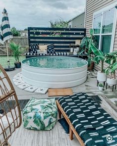 a backyard with an above ground swimming pool and patio furniture on the back deck area