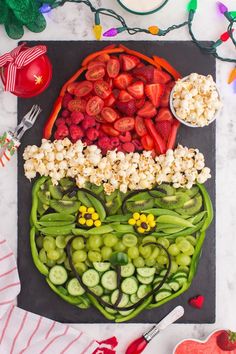 a platter filled with fruit and vegetables on top of a table