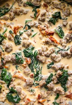 a casserole dish with meatballs and spinach in cream sauce on top