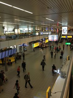 many people are walking through an airport terminal