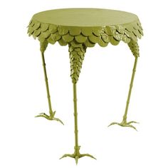 a yellow table with two legs that are made out of leaves and other things on it