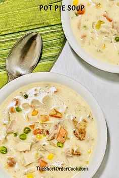 two white bowls filled with soup on top of a table