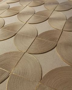 a close up view of a floor with gold circles on the ground and beige carpet