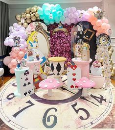 a large clock with balloons and other decorations on it's face in the middle of a room