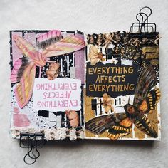 an altered book is sitting on a wooden table with butterflies and words written in it