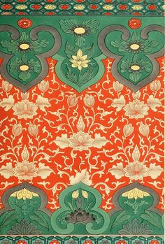 an orange and green wallpaper with floral designs on the border, in front of a red background