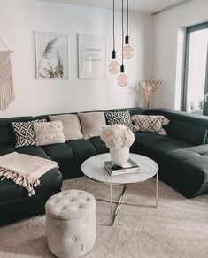 a living room filled with lots of furniture next to a large window and a rug on the floor