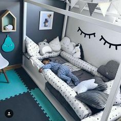 a child's room with a bed and toys on the floor