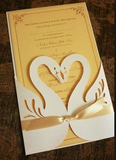 a wedding card with two swans on it