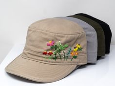 This hand embroidered flower baseball cap is a one-of-a-kind accessory that combines style and comfort. The cap is crafted from high-quality material, ensuring durability and comfort. The intricate floral design is hand-embroidered, giving each cap a unique touch and making it a standout piece. Whether you're running errands or enjoying a day outdoors, this cap will keep the sun out of your eyes in style. Flower is 100% hand embroidered on a 100% cotton wash cadet cap. Hat is one size fits all with adjustable back strap. Unique cap, one of a kind! I am also open for customization. If you want the item in different colors, please message me, it will take additional 2-3 days of handling time. Free first class shipping, upgradable priority mail service. 30 days return policy, feel confident a Military Style Baseball Cap With Curved Brim, Embroidered Adjustable Flat Cap, Adjustable Embroidered Flat Cap, Hand Embroidered Flower, Summer Sun Hat, Flat Cap, Flower Applique, Summer Sun, Sun Hat