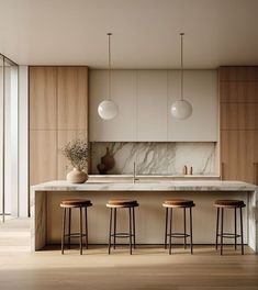 a kitchen with marble counter tops and stools