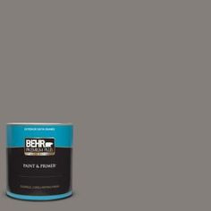 a can of behr paint and primer in one on a dark gray background