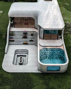 an aerial view of a futuristic house in the middle of a field with a swimming pool