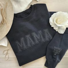 The ideal present for a mom is our super soft mama sweatshirt! It boasts a minimalistic, embossed puff design that exudes both comfort and style, making it perfect for home and running around. To make it even more unique, personalize the left (outside) sleeve with the children's names, adding a special touch that mom will cherish. We offer a beautiful selection of sweatshirt colors and puff wording colors. SHOWN IN MAIN PICTURE - BLACK w/ BLACK PUFF Sizes: SM - 2XL (We do carry some colors in 3X Black On Black Puff Vinyl, Diy Sweatshirt Ideas Vinyl, Black On Black Sweatshirt, Mama Puff Vinyl Sweatshirt, Diy Sweatshirt Ideas Iron On, Puffy Vinyl Sweatshirt, Mother's Day Black Crew Neck Sweatshirt, Casual Black Sweatshirt For Mother's Day, Puff Vinyl Ideas