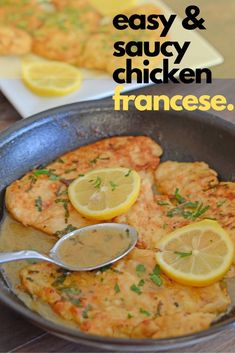 some chicken in a pan with lemons and sauce