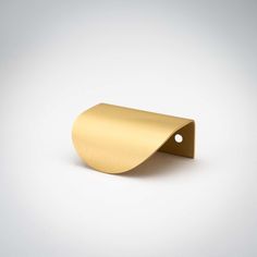 a gold metal object on a white background