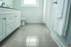 a bathroom with white fixtures and tile flooring