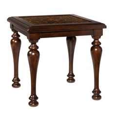 a small wooden table with an intricate design on it's top and bottom legs