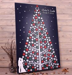 a christmas card with a tree and snowflakes in the shape of a bride and groom