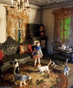 a doll house living room with furniture and toys