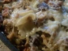 a casserole dish with meat and cheese on it