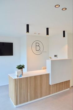 the reception area is clean and ready for customers to use in this modern, white office