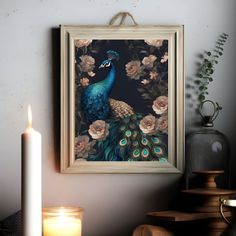 a peacock is sitting on a table next to a candle