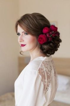 a woman with red flowers in her hair