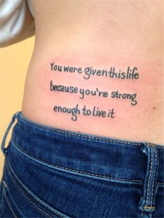 a woman's stomach with a tattoo saying you were given this life because you're strong enough to live it