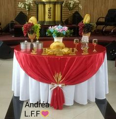 a table with red and white cloth on it is set up for a banquet or party