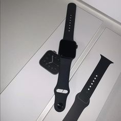 two apple watch bands sitting next to each other on top of a white countertop