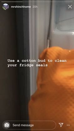 an orange towel hanging on the side of a refrigerator