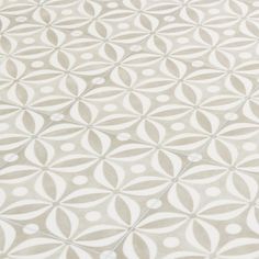 a beige and white rug with circles on it