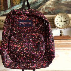 This Is A Black Backpack With Paint Splatter Design From The Brand Jansport. Black Backpack For End Of School Year Outdoor, Cute Jansport Backpacks, Blue Jansport Backpack, Black Jansport Backpacks, Sloth Backpack, Black Jansport, Jansport Right Pack, Jansport Superbreak Backpack, Floral Backpack