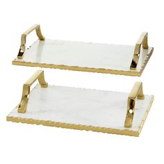 two gold and white trays with handles on each side, one holding a napkin