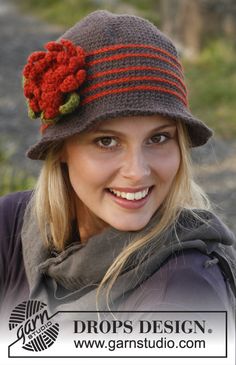 a woman wearing a hat with flowers on it