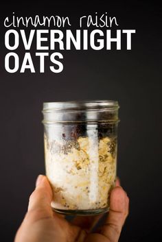 someone holding up a jar with overnight oats in it and the text overlay reads, cinnamon raisin overnight oats