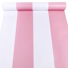 a pink and white striped table cloth on top of a roll of paper next to it